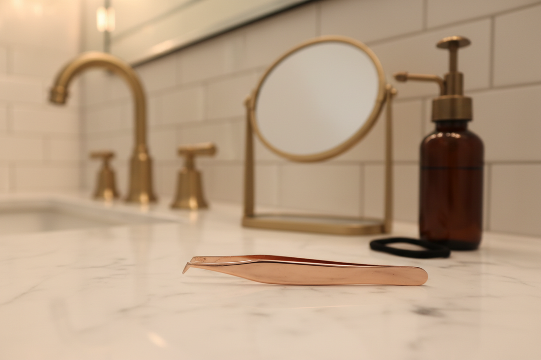 A pair of tweezers resting on a clean white surface — representing the androgen-driven chin hair and facial hair that comes with PCOS and the daily reality so many women navigate
