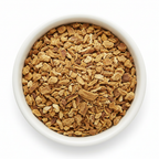 Dried yellow dock root cut and sifted pieces in a white ceramic bowl on a white background