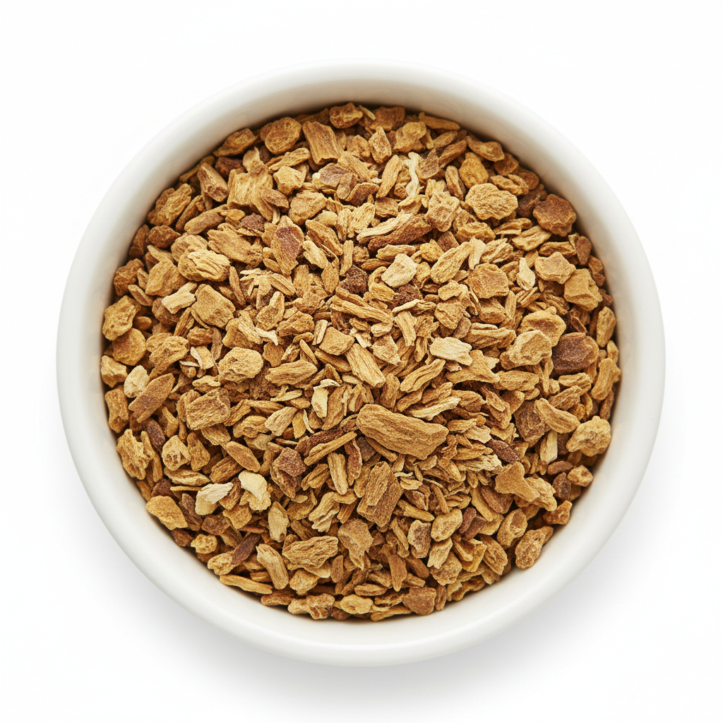 Dried yellow dock root cut and sifted pieces in a white ceramic bowl on a white background