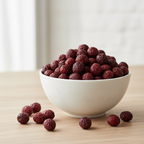 Organic whole hawthorn berries in a white ceramic bowl